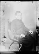 Ríproduzione di un ritratto: un uomo e´seduto su una stedia con un abito